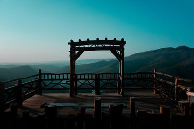 Wooden built structure against mountains and clear sky