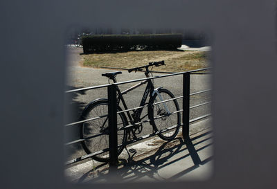 High angle view of bicycle parked by railing