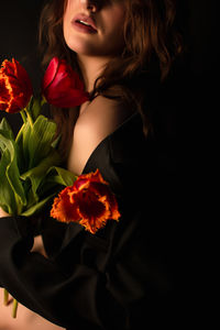 Portrait of woman with red roses