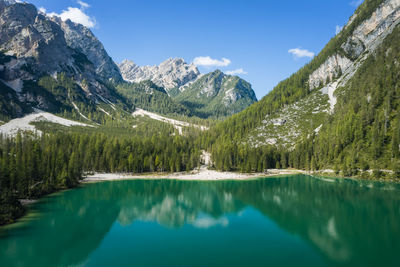 Scenic view of lake and mountains against blue sky