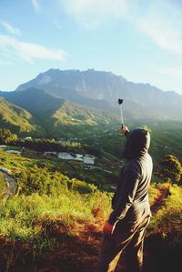 Rear view of man standing on golf course