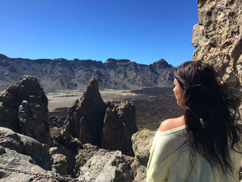 Young woman looking over the volcano teide