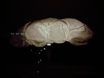 Close-up of human hand against black background