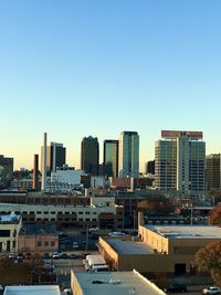 Modern buildings in city against clear sky