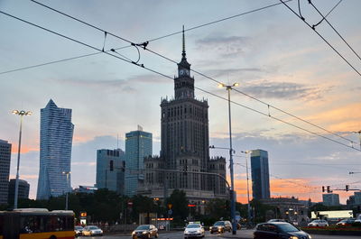 View of buildings in city against cloudy sky