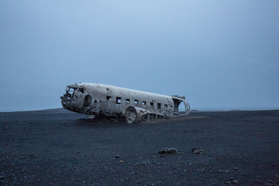 Old abandoned airplane against sky