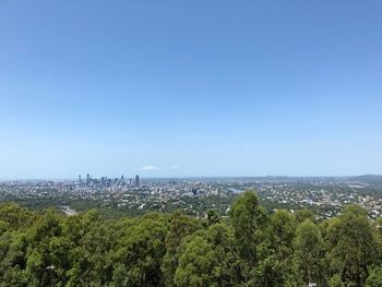 High angle view of trees and buildings against clear sky