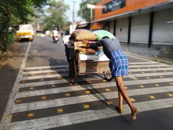 Rear view of man on sidewalk in city