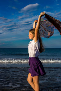 Low section of person standing on beach