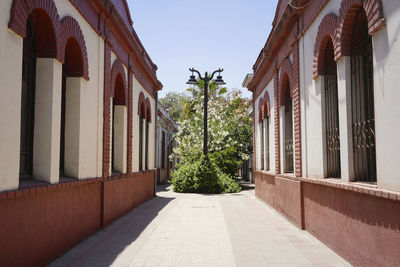 View of a narrow street between two red historic colonial buildings in santiago, chile