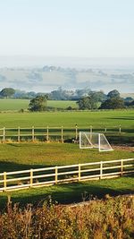 Goal post on playing field against sky