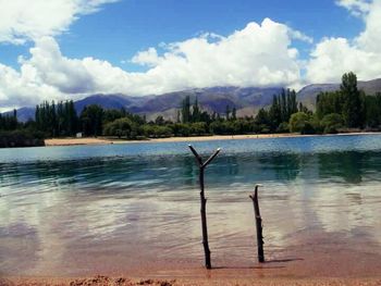 Scenic view of lake against cloudy sky