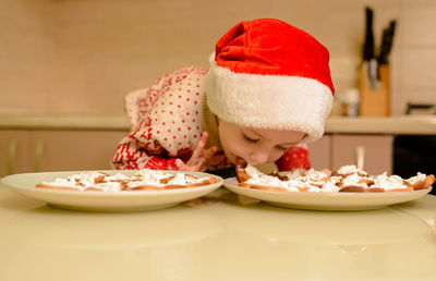 Little boy bake homemade festive gingerbreads. kid cooking cookies