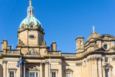 Low angle view of hbos headquarters against clear blue sky