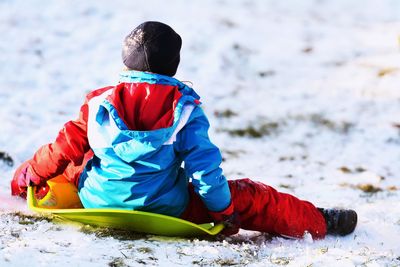 Rear view of boy in snow