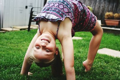 Portrait of happy girl exercising in lawn