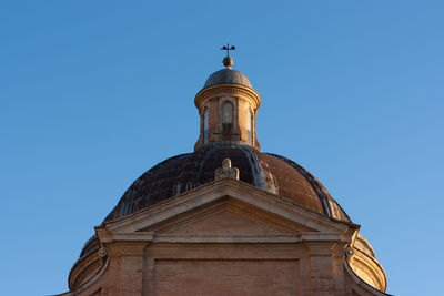 Low angle view of historic building against clear blue sky