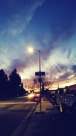 View of city street against cloudy sky