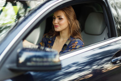 Portrait of young woman in car