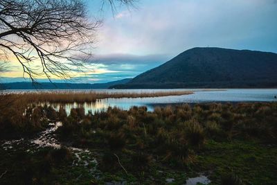 Scenic view of lake against cloudy sky