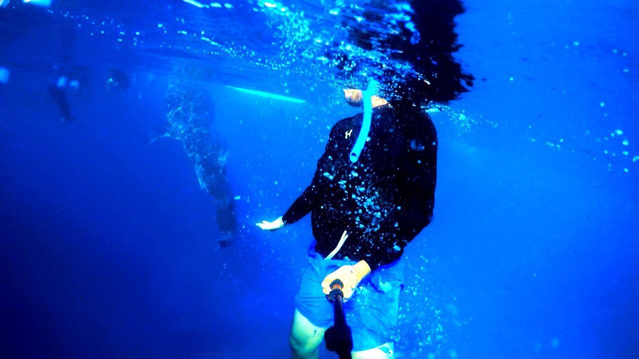 MAN SWIMMING IN SEA