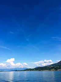 Scenic view of sea against blue sky