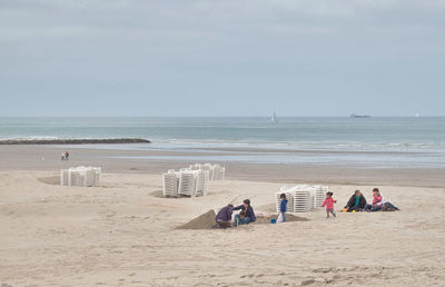 People on beach against sky