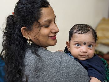 Close-up of mother and daughter at home