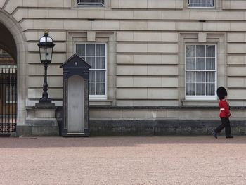 Full length of woman standing in front of building
