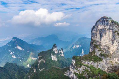 Scenic view of mountain range against cloudy sky