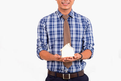 Mid adult man standing against white background