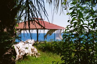 Built structure by trees against clear sky