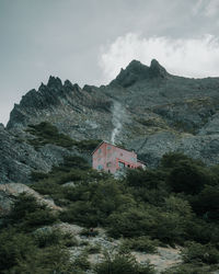 Low angle view of houses and mountains against sky