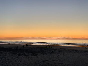 Scenic view of beach against sky during sunset