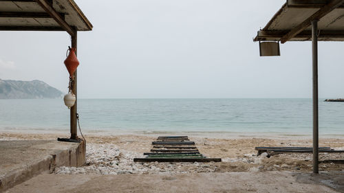 Lifeguard hut on beach against clear sky