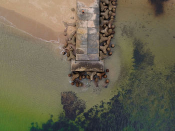 High angle view of old metallic wall by water