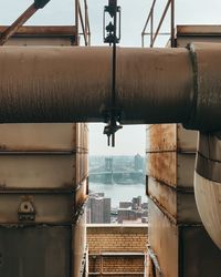 Close-up of metal pipe by river in city