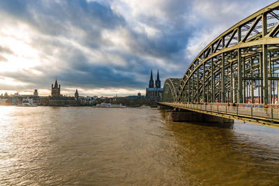 View of bridge over river against cloudy sky