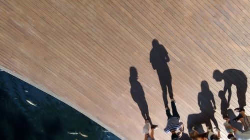 High angle view of people standing on wooden boardwalk