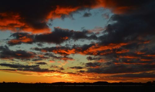 Silhouette landscape against scenic sky