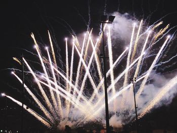 Low angle view of firework display at night