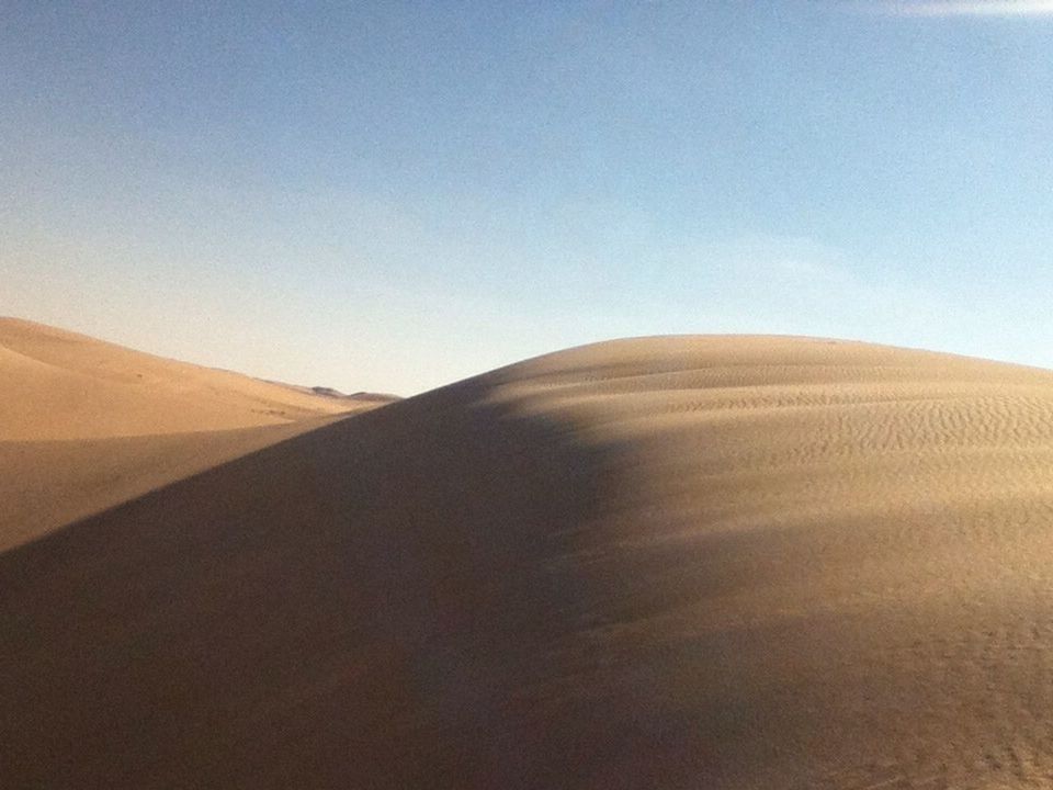 SAND DUNES AGAINST SKY