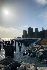 Panoramic view of sea and buildings against sky