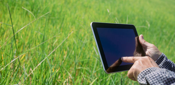 Man using mobile phone in grass