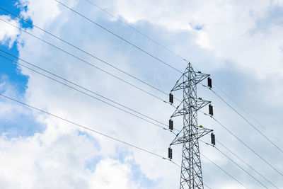 Low angle view of electricity pylon against sky