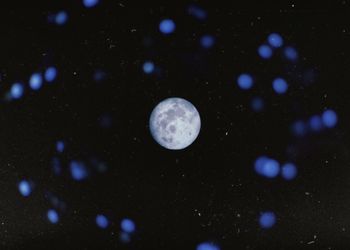 Close-up of sea against moon at night