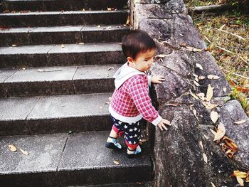 Cute boy standing on steps