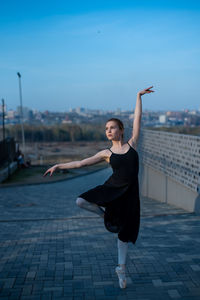 Full length of woman dancing in city