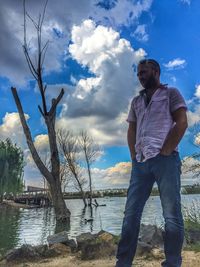 Scenic view of river against cloudy sky