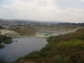 Scenic view of river and landscape against sky